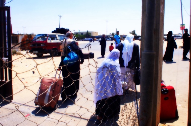 Palestinian elderly people dragging their luggage and returning back home after hearing of the closure of Rafah border